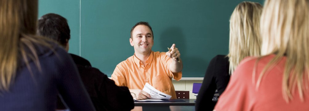 male-teacher-points-to-call-on-student.jpg